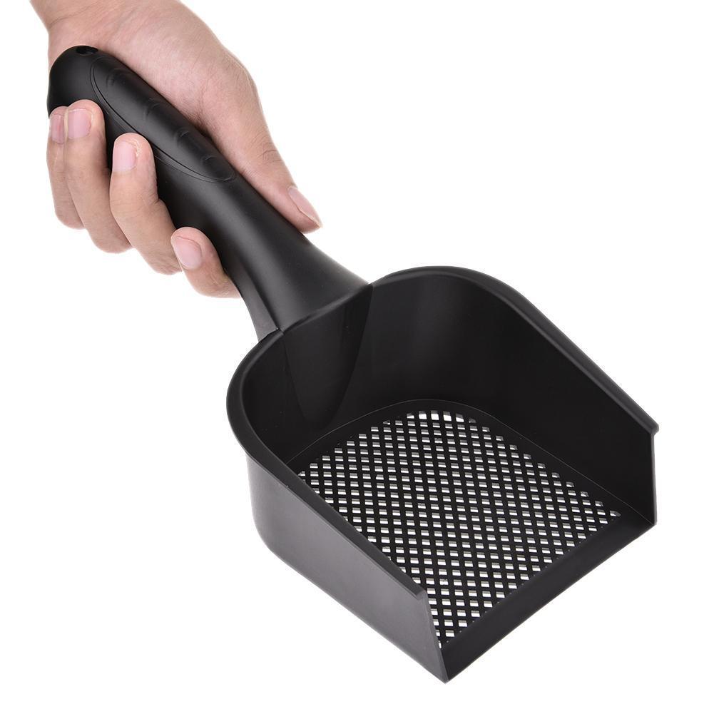 Black plastic cat litter scoop with perforated tray held in a hand