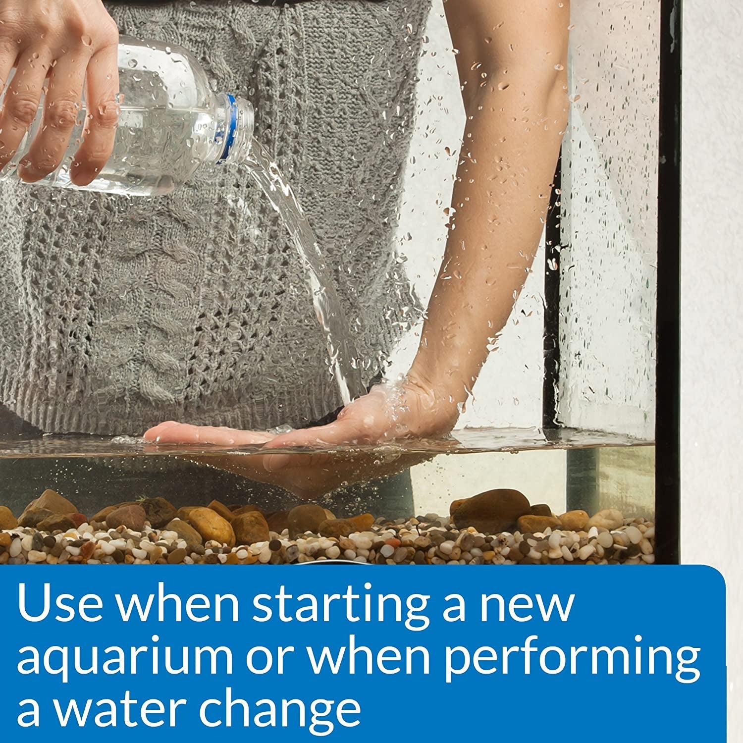 Hand pours clear water into aquarium tank; Aquarium Salt treatment use.