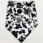 Pet triangle bandana in black and white with Halloween cats, spiderwebs, bats, and stars