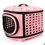 Foldable pet carrier handbag in pink with perforated side panels and mesh window