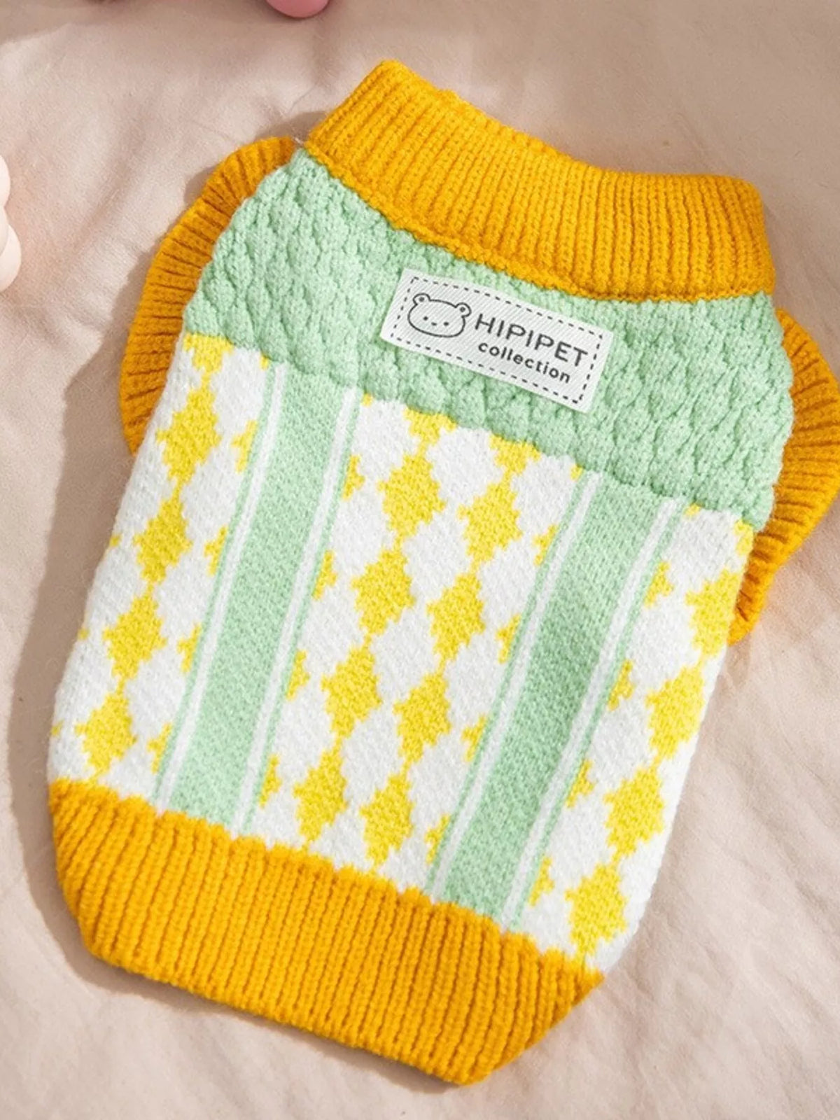 Mint green and white knitted pet sweater with yellow argyle pattern and yellow cuffs