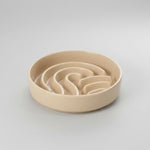 Beige wave slow feeder dog bowl with wavy channels inside, no stand