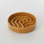 Orange wave slow feeder dog bowl with wavy channels inside, no stand