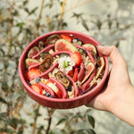 Pink/red wave slow feeder dog bowl filled with food and wavy channels