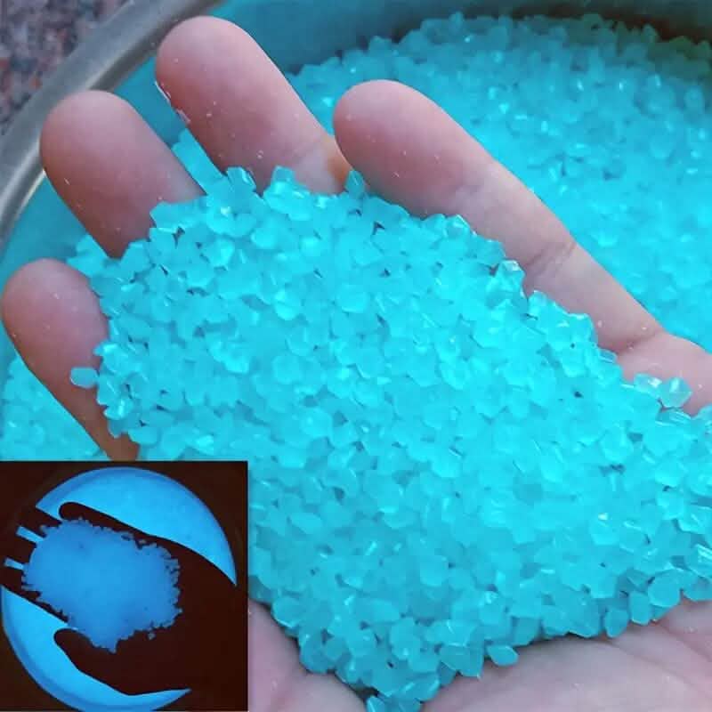 Blue luminous glowing stones, small faceted pieces held in an open hand