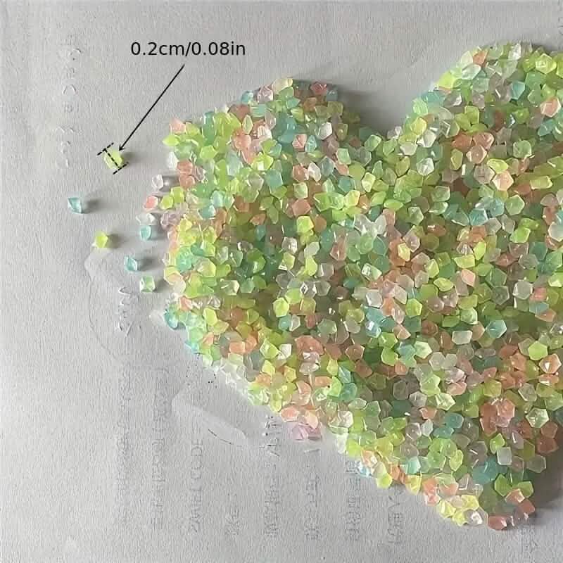 Iridescent luminous glowing stones, small faceted pieces on a flat surface