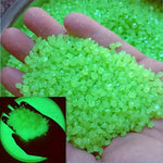 Green luminous glowing stones, small faceted pieces held in an open hand