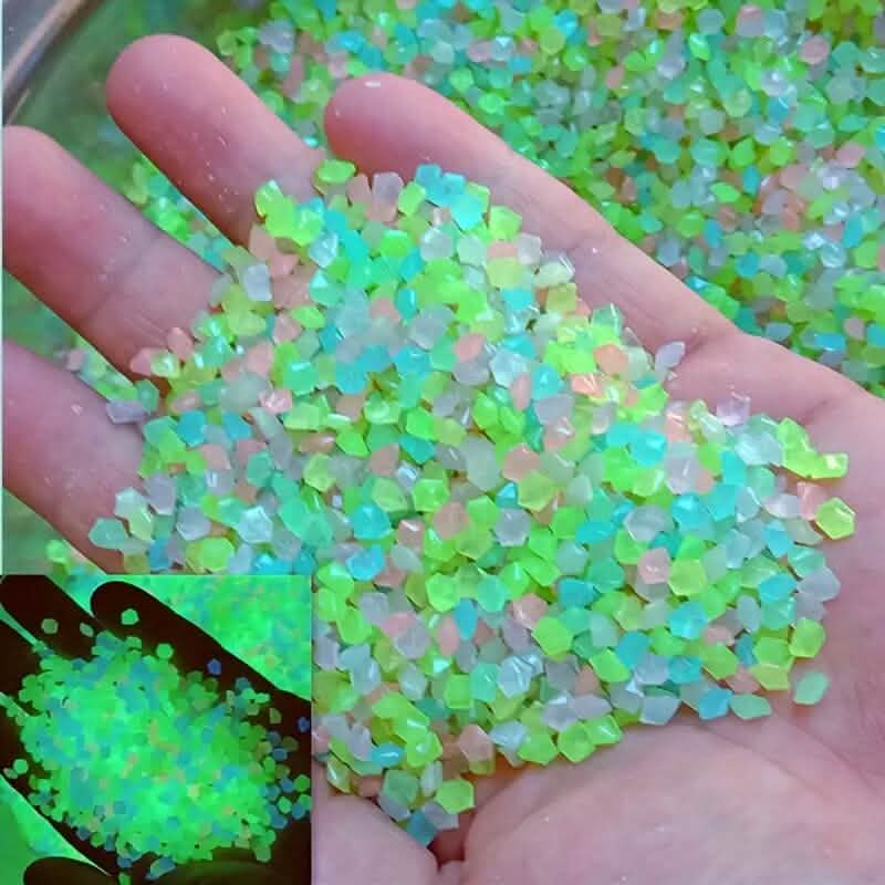 Multicolor luminous glowing stones, small faceted pieces held in an open hand