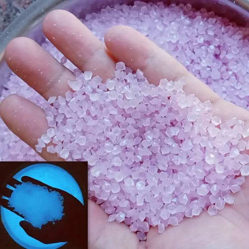 Purple luminous glowing stones, small faceted pieces held in an open hand