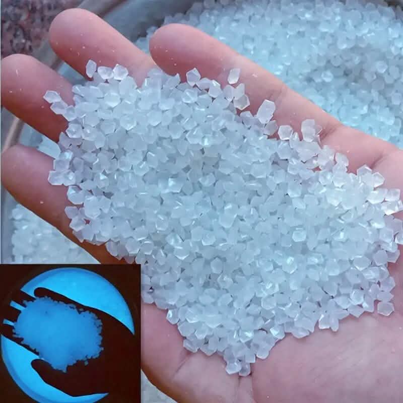 White luminous glowing stones, small faceted pieces held in an open hand