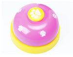 Pink paw press pet training bell with yellow button and paw-print detail