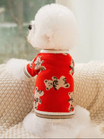 Red knitted pet sweater with cartoon animal pattern and striped ribbed trim