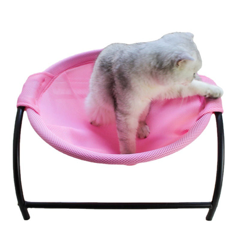 Pink pet hammock bed with black frame, gray-and-white cat curled up