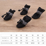 Black dog soft-soled pet shoes with light gray ruffle trim and lace toggles