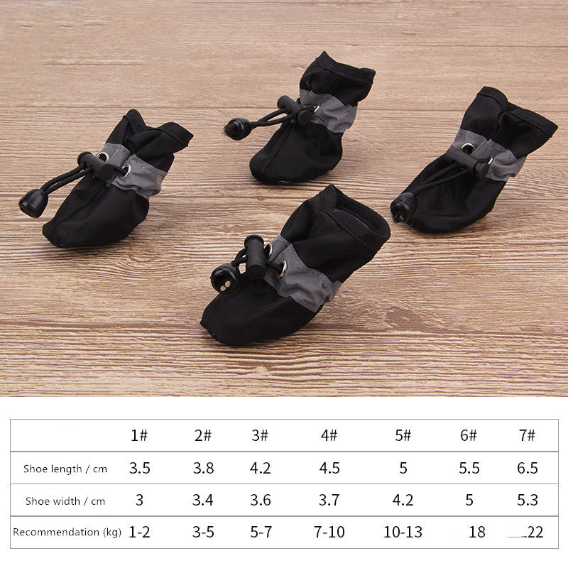 Black dog soft-soled pet shoes with light gray ruffle trim and lace toggles