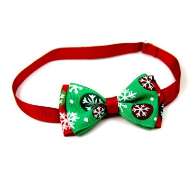 Christmas bow tie for pets with red neck strap and green holiday-pattern bow