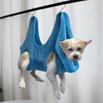 Blue pet grooming hammock restraint bag with four leg openings and hanging loops