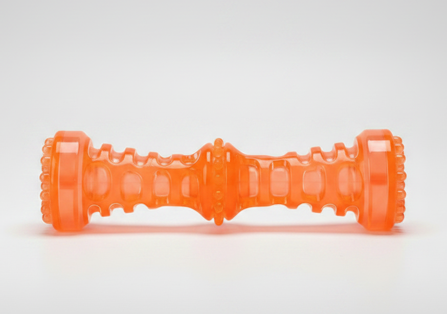 Orange squeaky dog chew bone toy lying down, ribbed center and end grips.