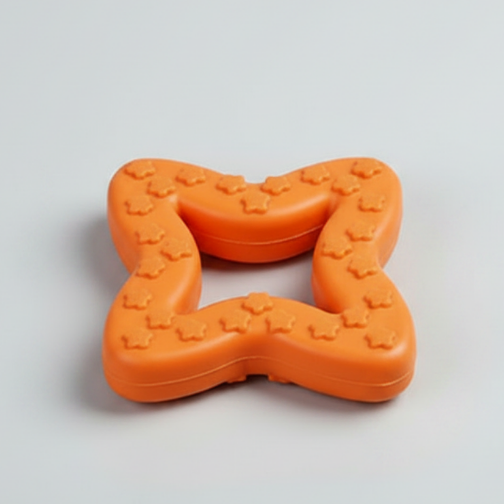Orange star-shaped rubber chew toy with raised paw nubs and a bite opening.