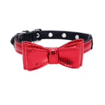 Black pet collar with red bow, crocodile-textured look, and silver grommet studs