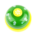Green pet training bell with yellow paw button and white paw-print details