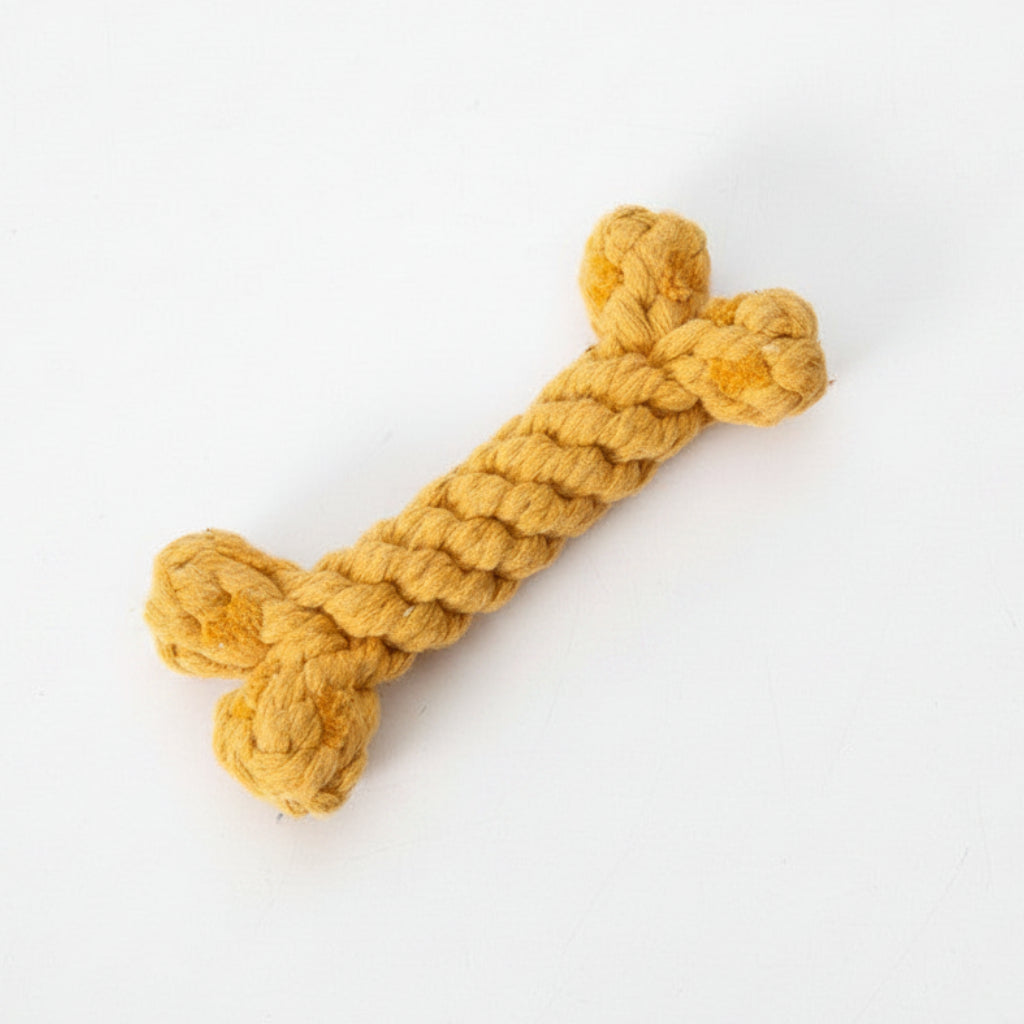 Golden yellow crocheted dog bone toy with knotted ends