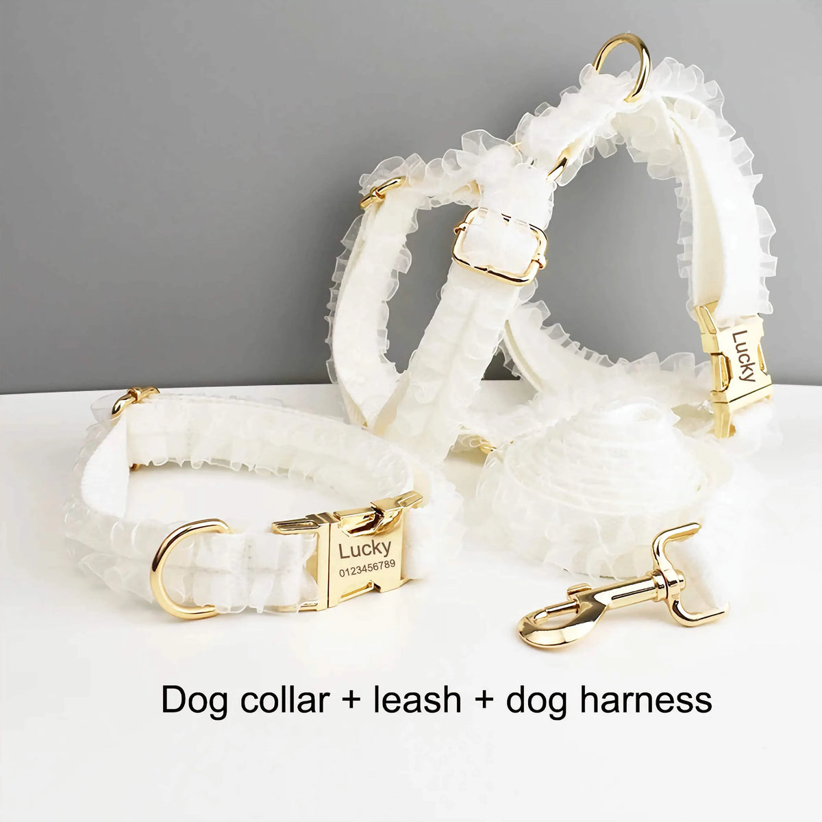 White ruffled dog collar, leash, and harness set with gold-tone clasps and rings