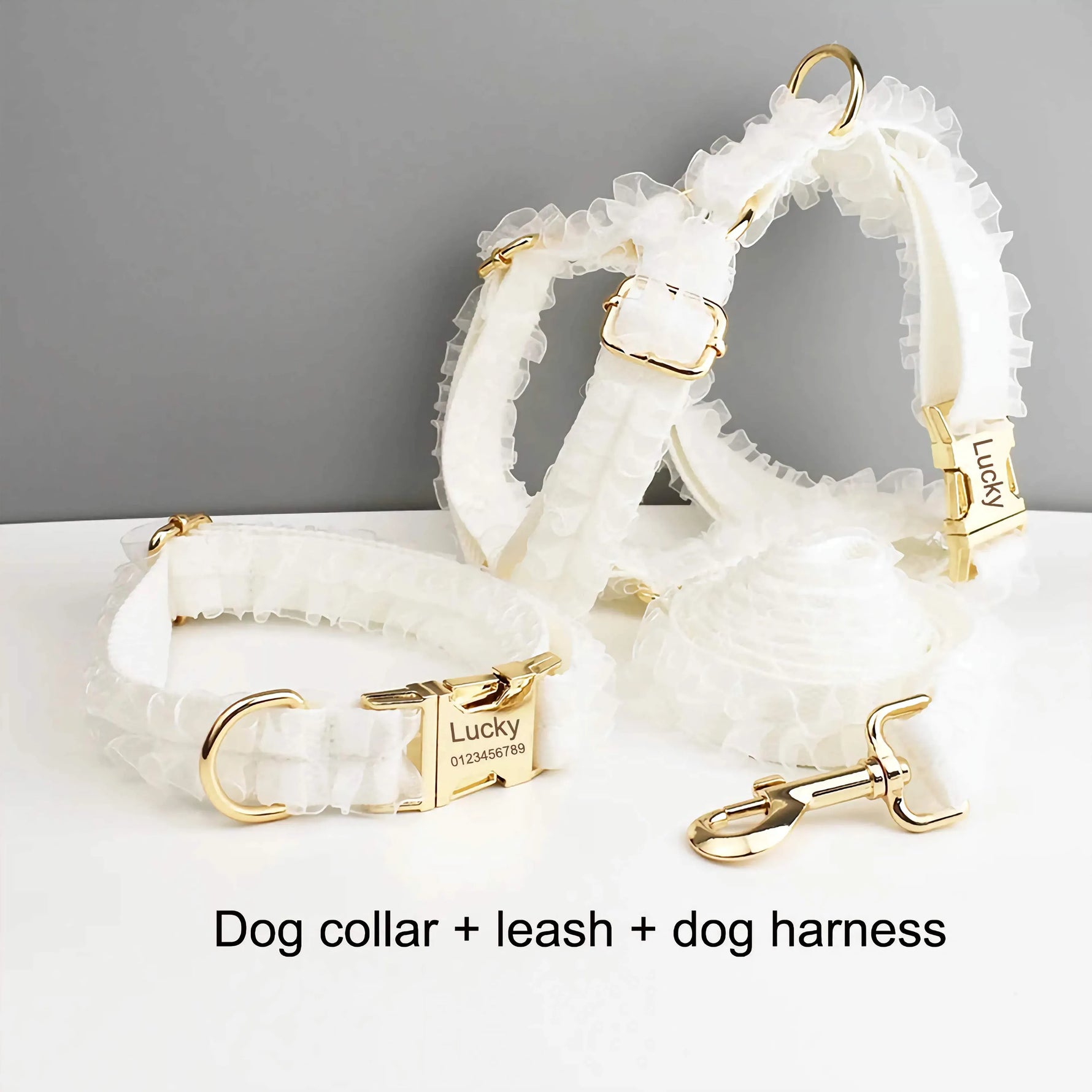 White ruffled dog collar, leash, and harness set with gold-tone clasps and rings