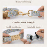 Floral dog collar with detachable bowtie and gold metal buckle, held for showing