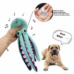 Six-claw fish plush dog toy, mint-green with purple tentacles; hand squeezes squeaky toy