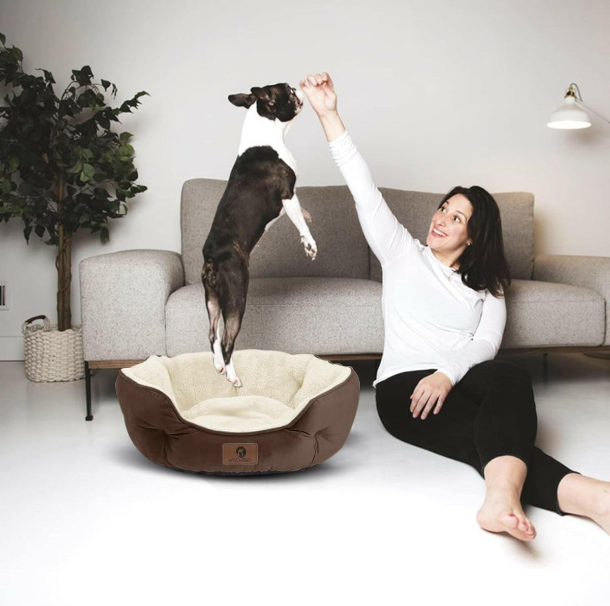 Sherpa fleece pet bed with brown outer and cream inner cushion, shown on the floor