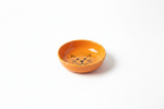 Orange cat food bowl with cat-face pattern and shallow round rim