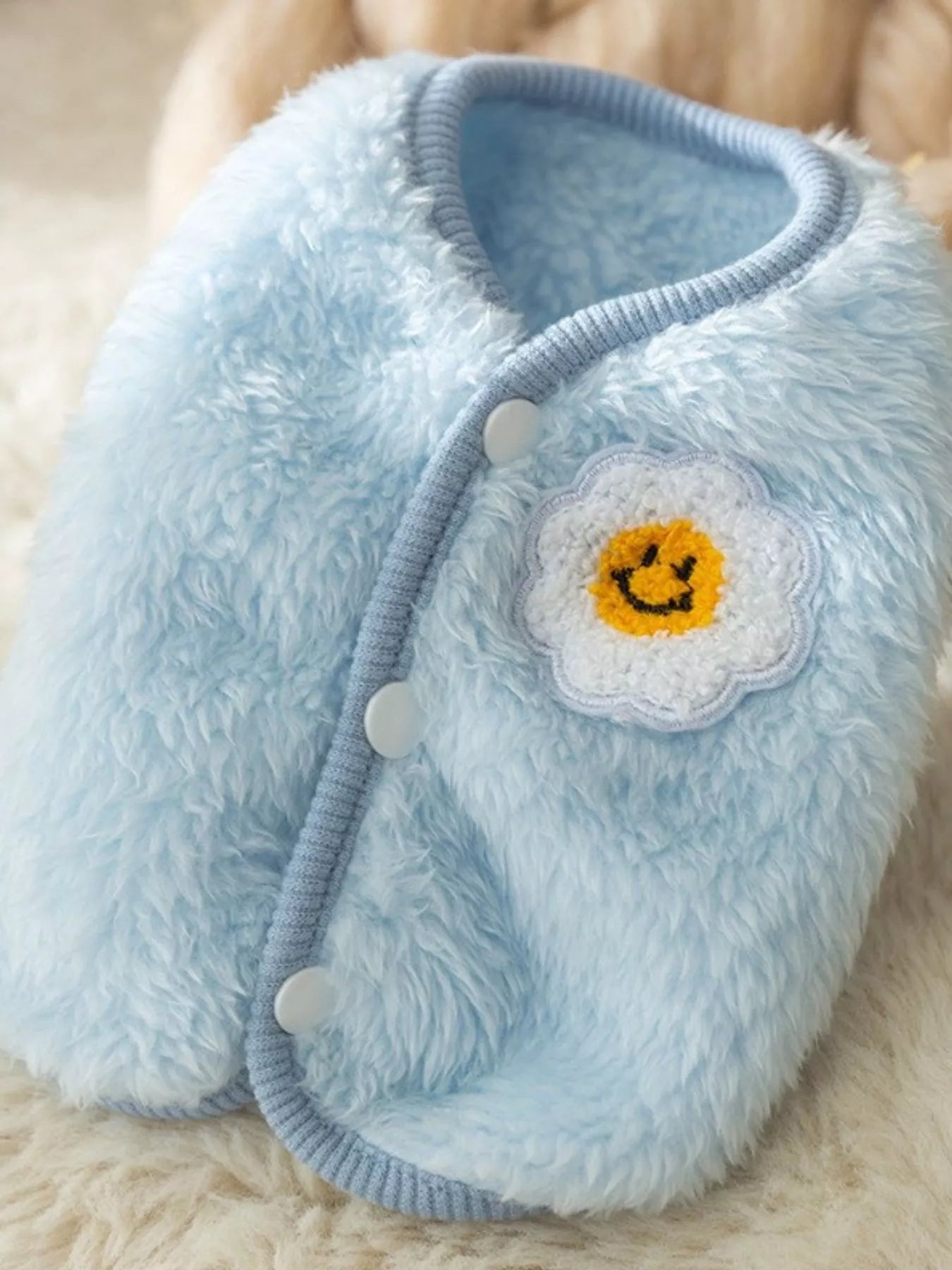 Light blue plush pet sweater with cloud smile patch and snap-button closure