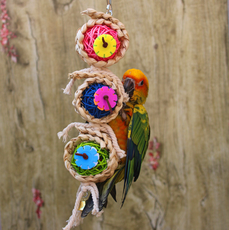 Bird bite toy with braided vine balls and colorful gear wheels, hanging on string