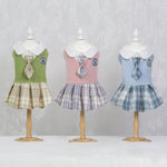 Tartan dress set for pets: green, pink, and blue plaid skirt dresses on mannequins