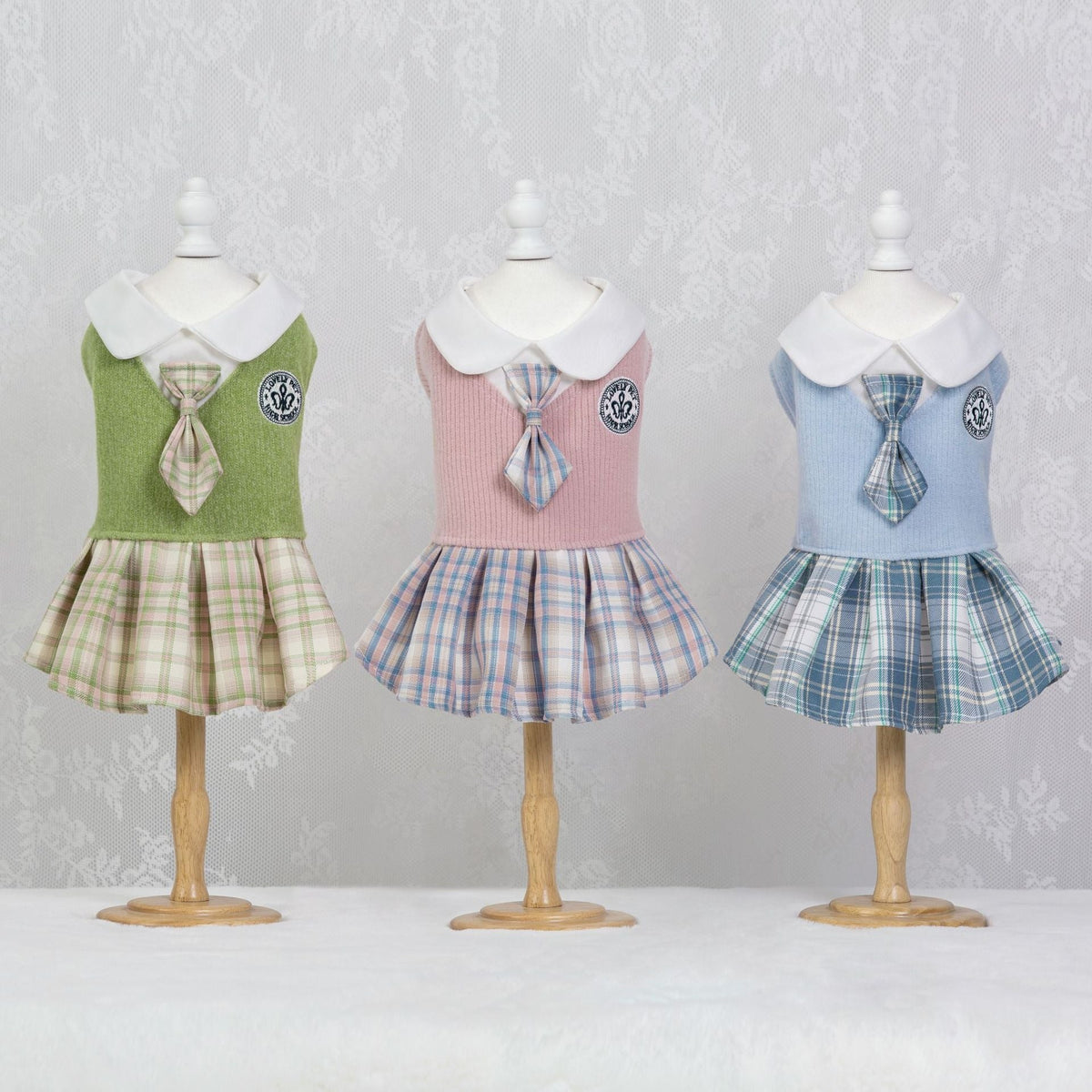 Tartan dress set for pets: green, pink, and blue plaid skirt dresses on mannequins