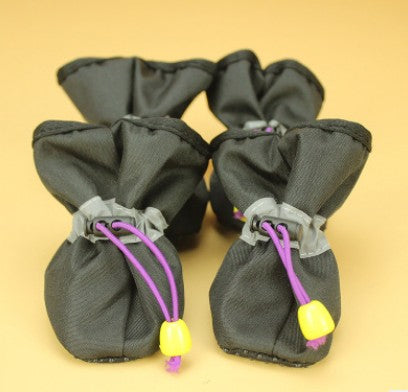 Dark gray soft dog boots with lace-up cords and small yellow sole studs