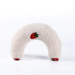 White plush U-shaped cat pillow toy with red fruit patches
