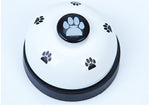 White paw press pet training bell base with black paw button in the center