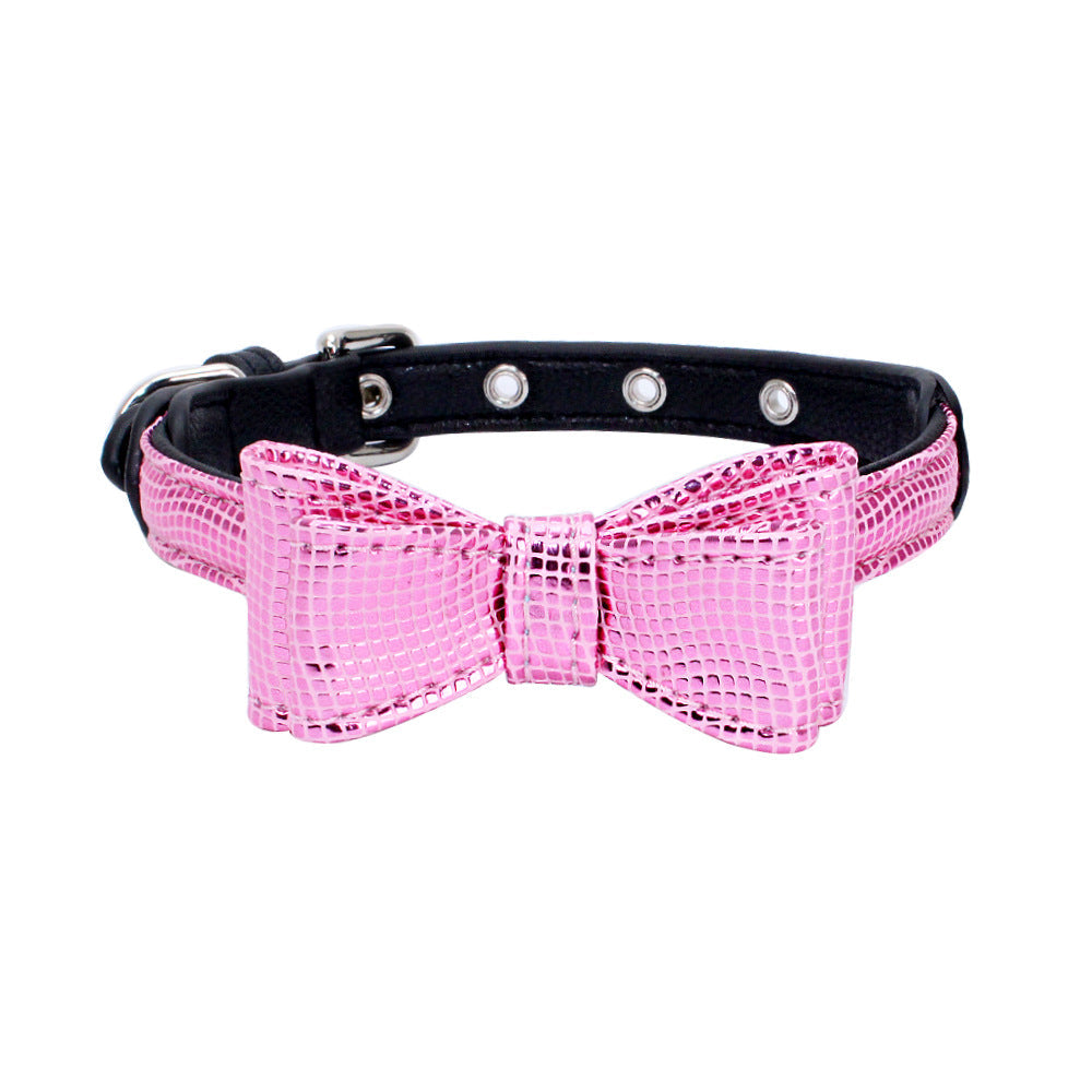 Pet collar with black strap and bright pink textured bow, silver grommet studs