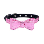 Pet collar with black strap and bright pink textured bow, silver grommet studs