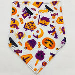 Pet triangle bandana with white fabric and colorful Halloween silhouettes in purple, orange, and yellow