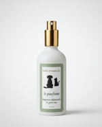 White pet spray bottle with gold pump and green label featuring cat and dog icons