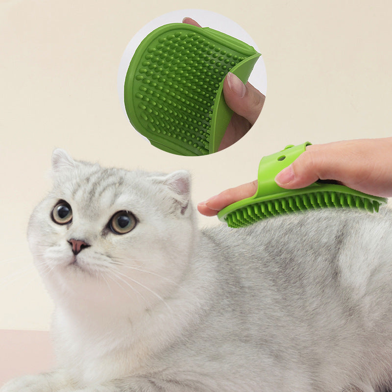 Green silicone pet massage brush being used on a gray cat