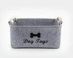 Light grey felt storage basket with dog bone emblem and side handles