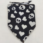 Pet triangle bandana in black with white hearts and skull-and-crossbones patterns
