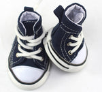 Pair of navy canvas dog shoes with white laces and padded ankle openings