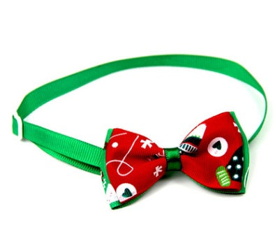 Christmas bow tie for pets with green neck strap and red holiday-icon bow