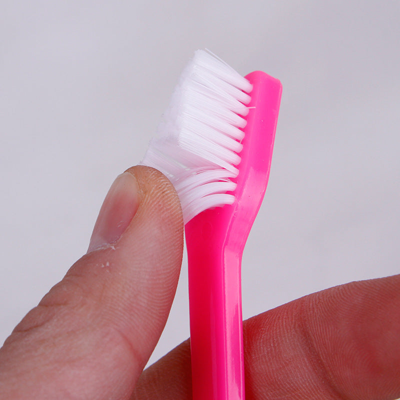 Pink pet finger toothbrush with soft white bristles