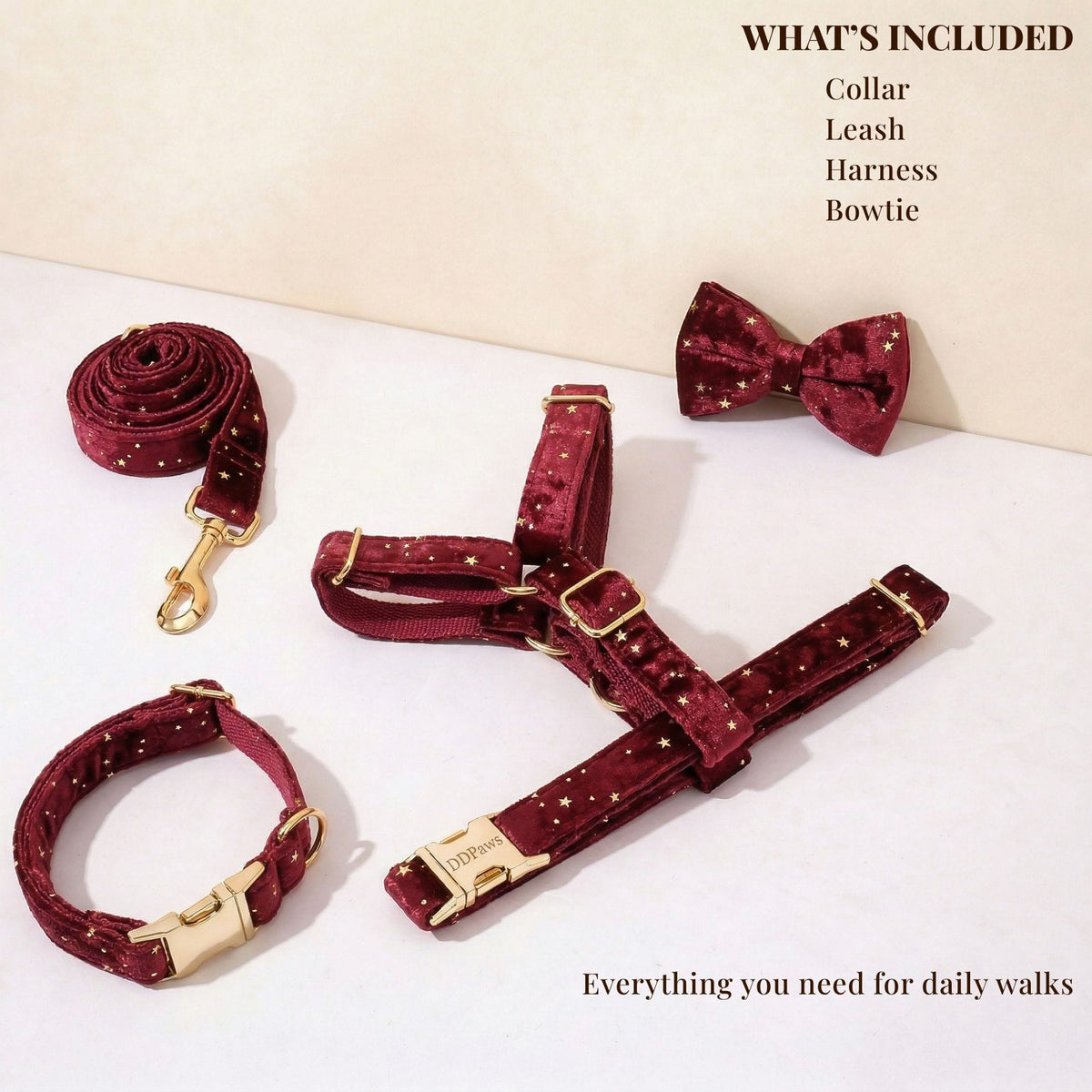 Star-pattern velvet dog collar, leash, and bowtie set laid flat with gold hardware